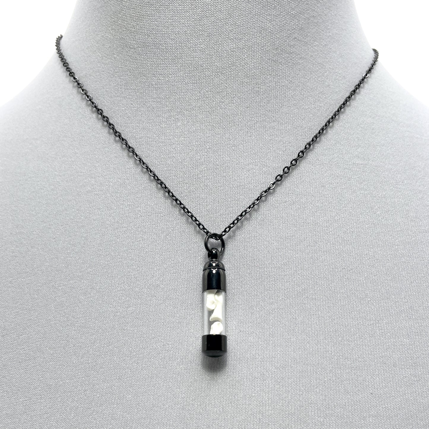 Tiny Black Glass Vial Filled with Little Bones