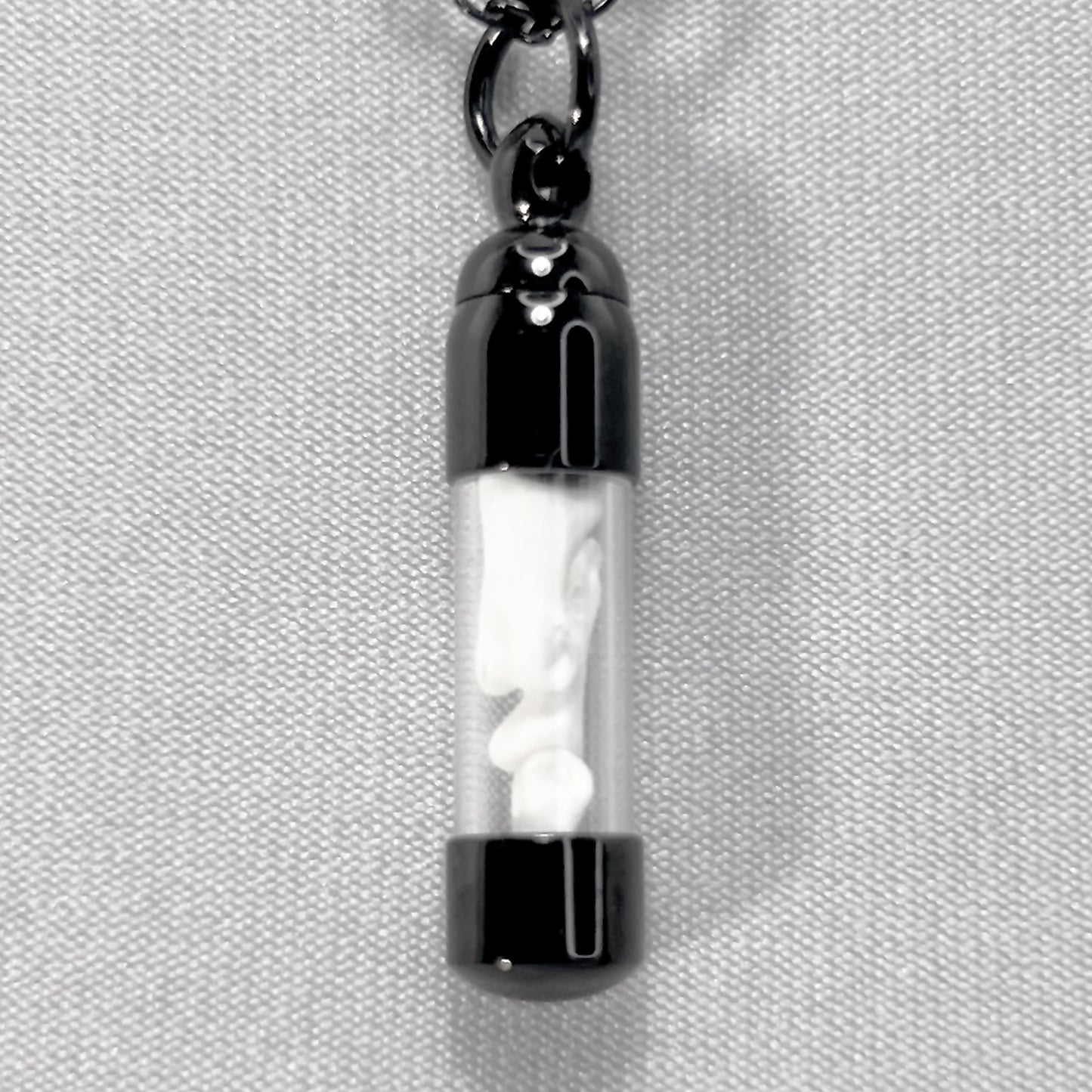 Tiny Black Glass Vial Filled with Little Bones