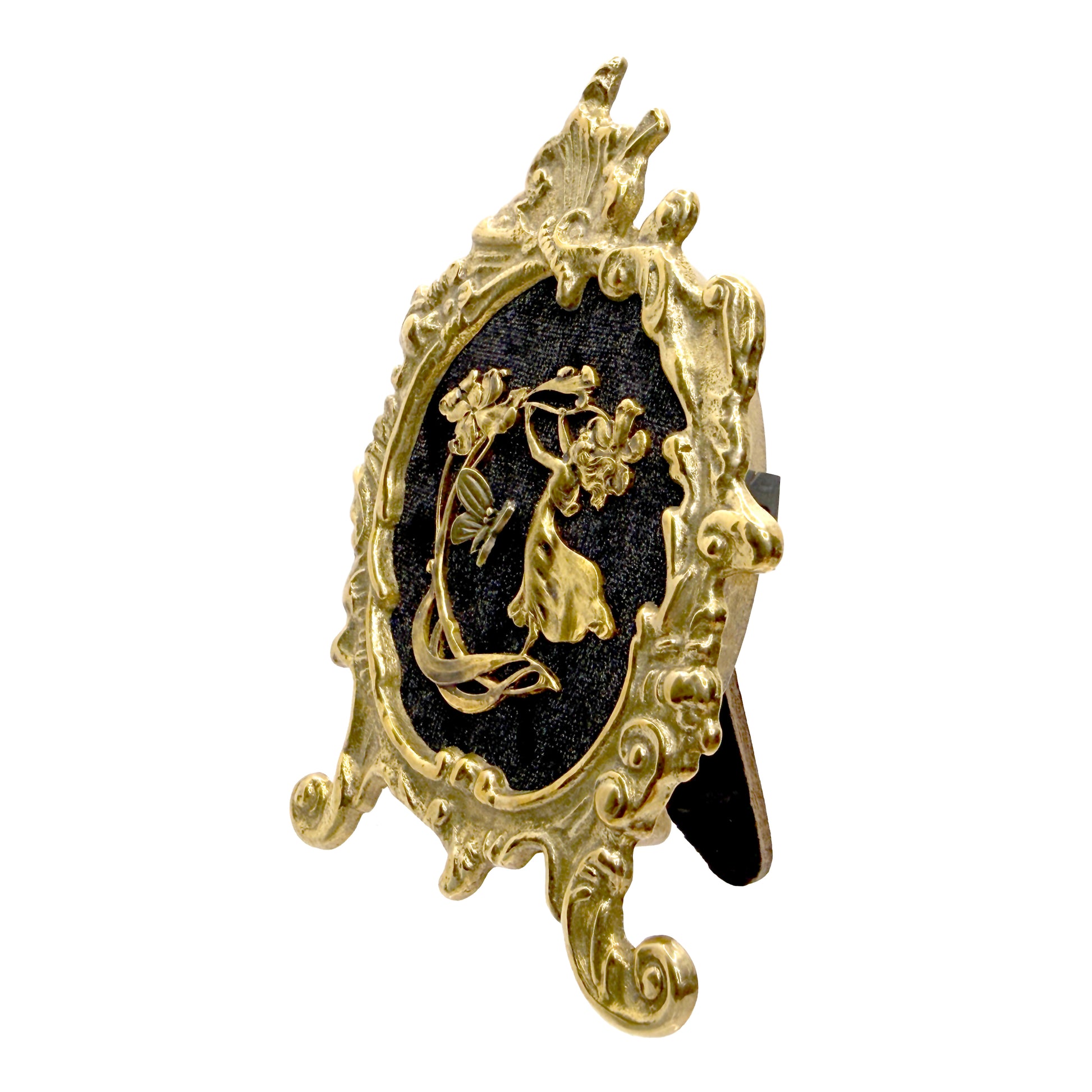 Decorative antique frame with gold fairy on black velvet featuring a floral design on a white background