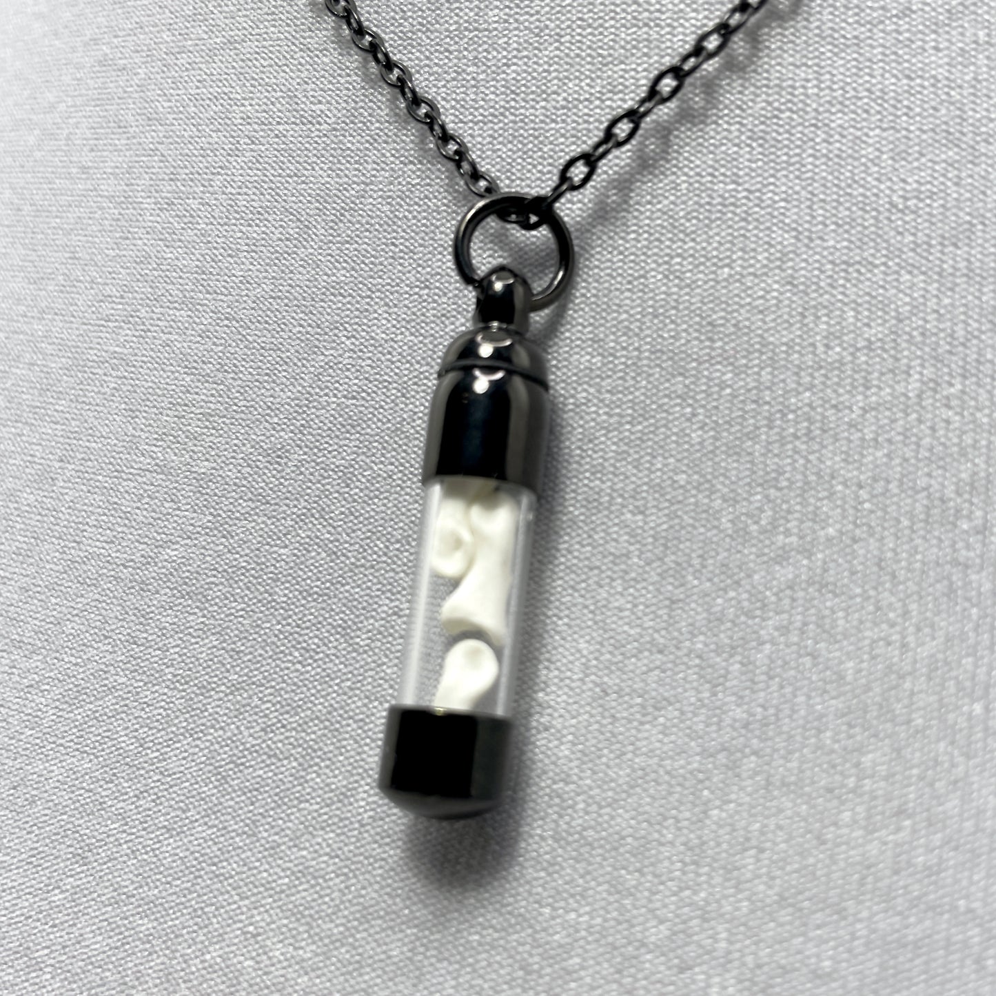 Tiny Black Glass Vial Filled with Little Bones