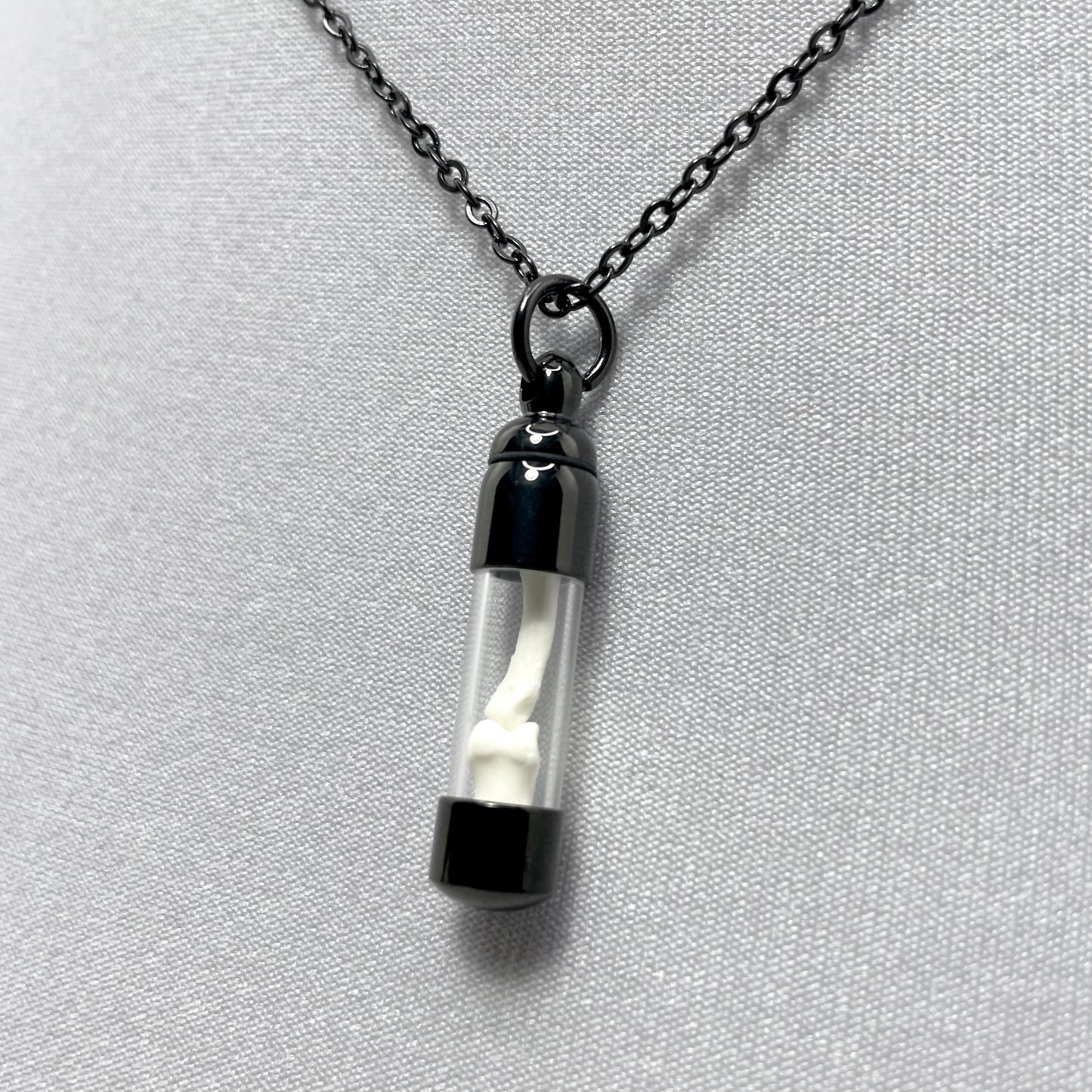 Tiny Black Glass Vial Filled with Little Bones