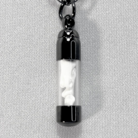Tiny Black Glass Vial Filled with Little Bones